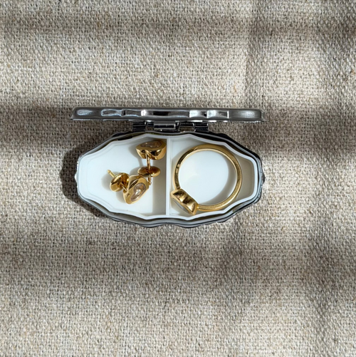 Twrad petite silver jewellery box open, showing padded interior